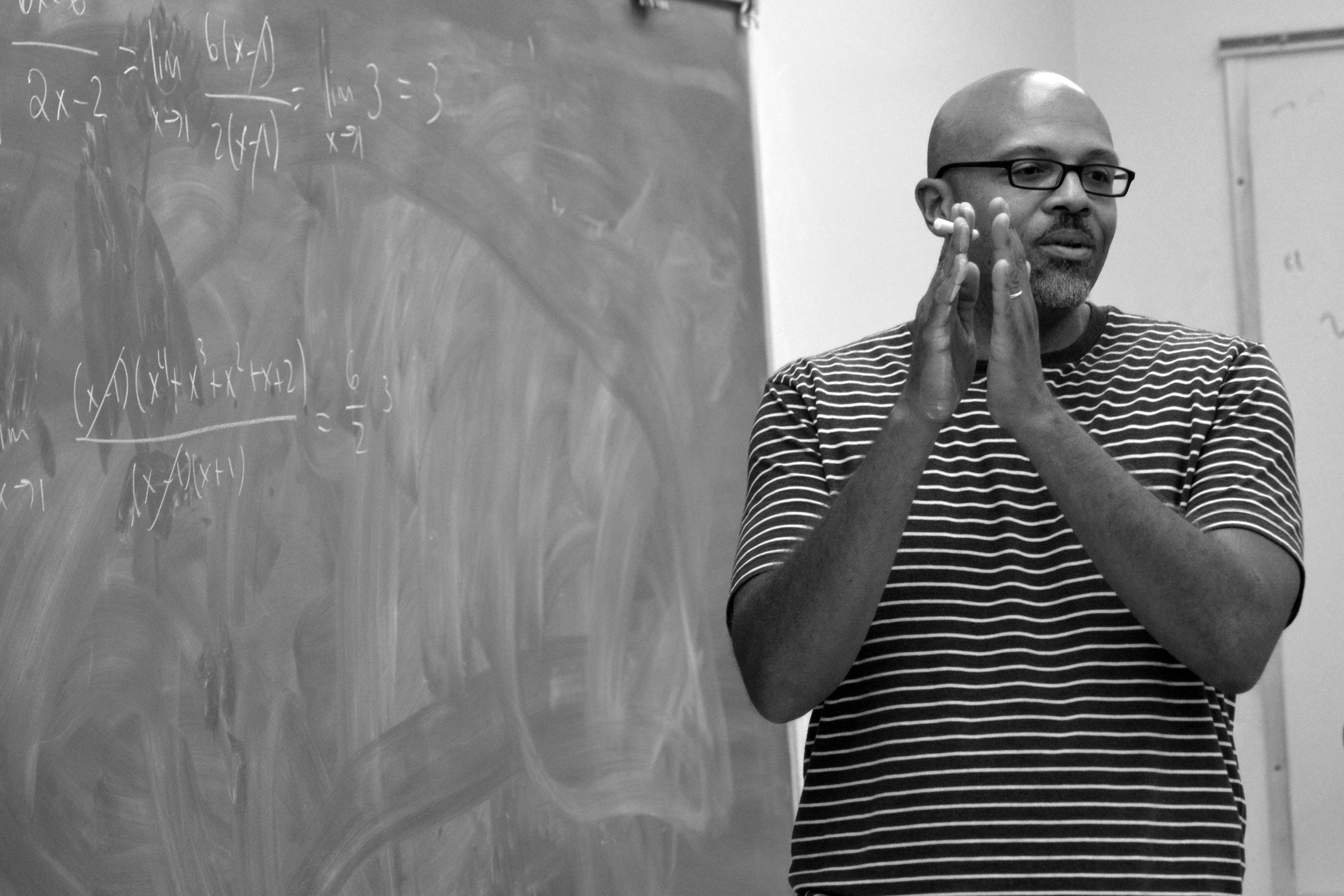 Robin Wilson teaching while in front of a chalkboard